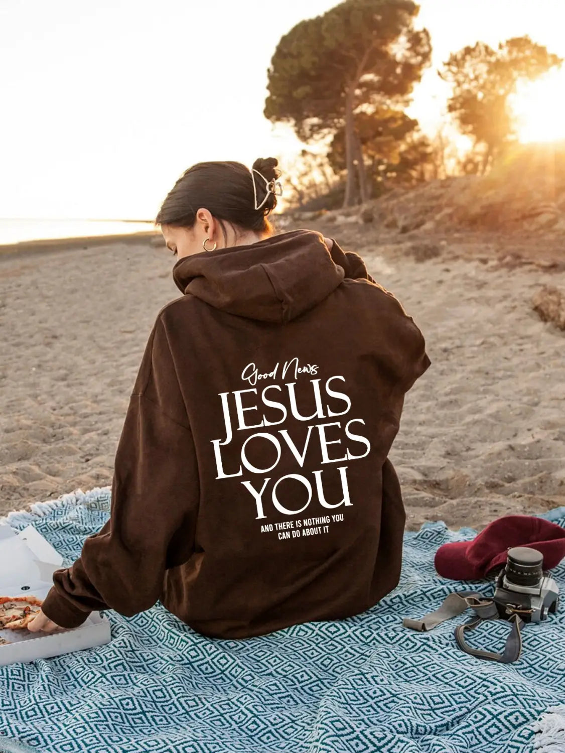 brown oversized streetwear kangaroo pocket hoodie with jesus loves you printed in white lettering on the back side