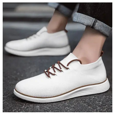 Men’s flyknit casual breathable lace up sneakers in white knit with brown laces and a layered rubber sole.