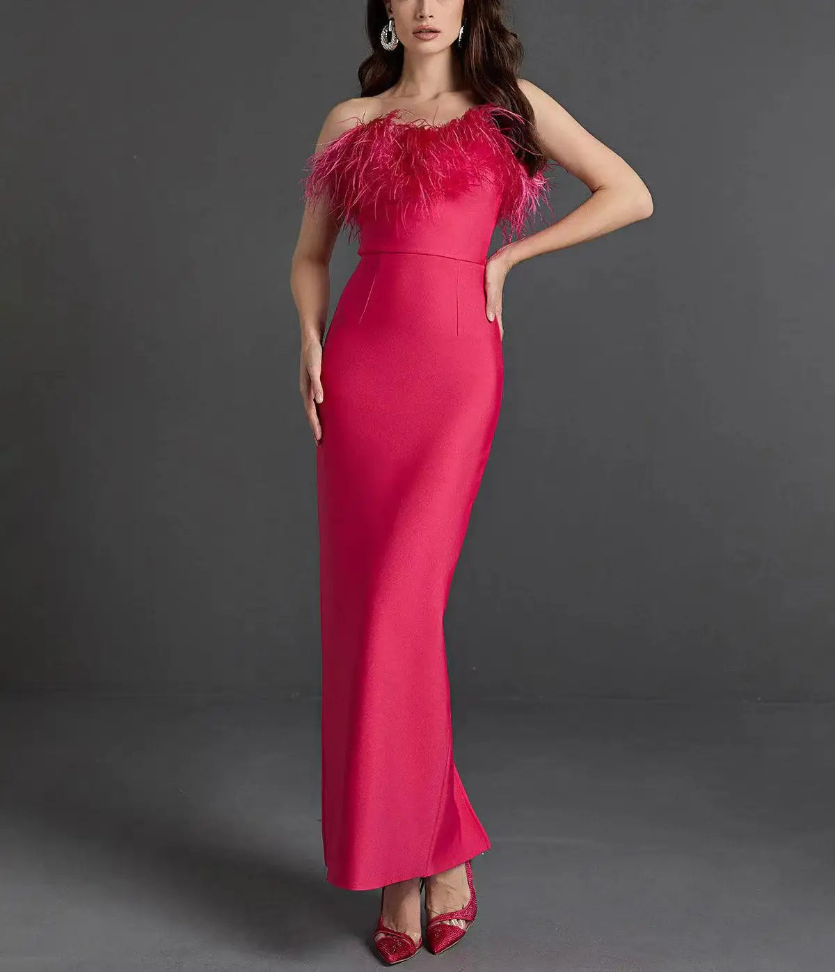 A vibrant fuchsia satin strapless mermaid evening gown with feathered shoulder detail.