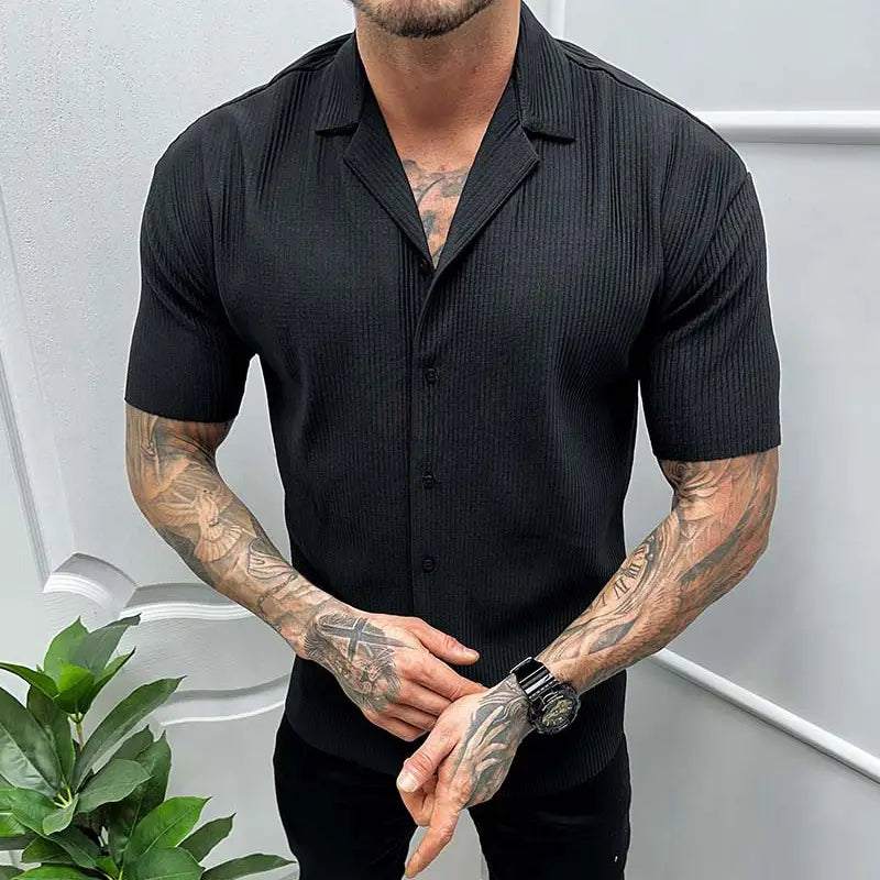 Men’s ribbed knit short sleeve button up shirt in black with a ribbed texture shown from the front.
