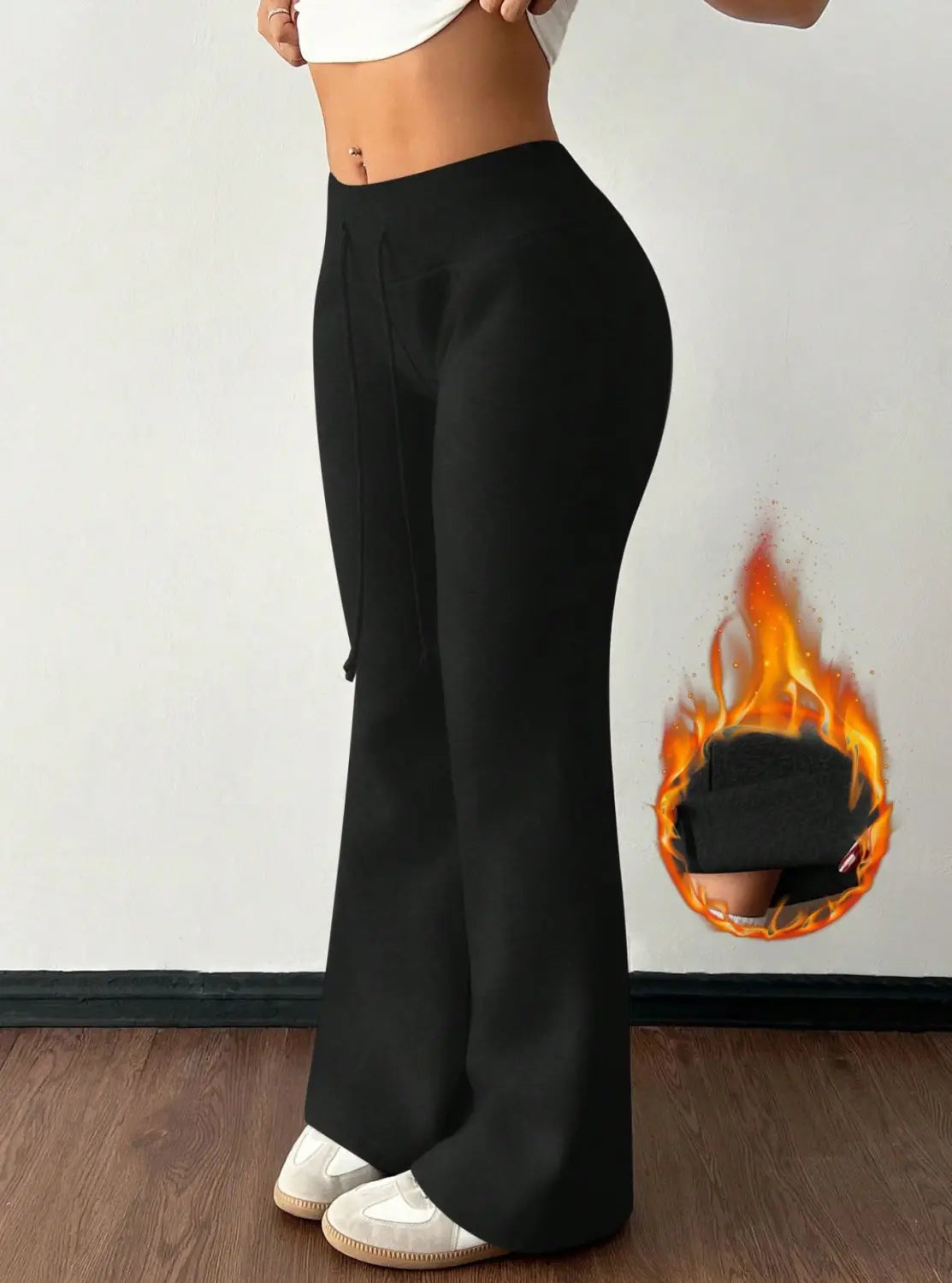 black fleece lined high waist flared sweatpants featuring a cozy insulated lining for added warmth and comfort