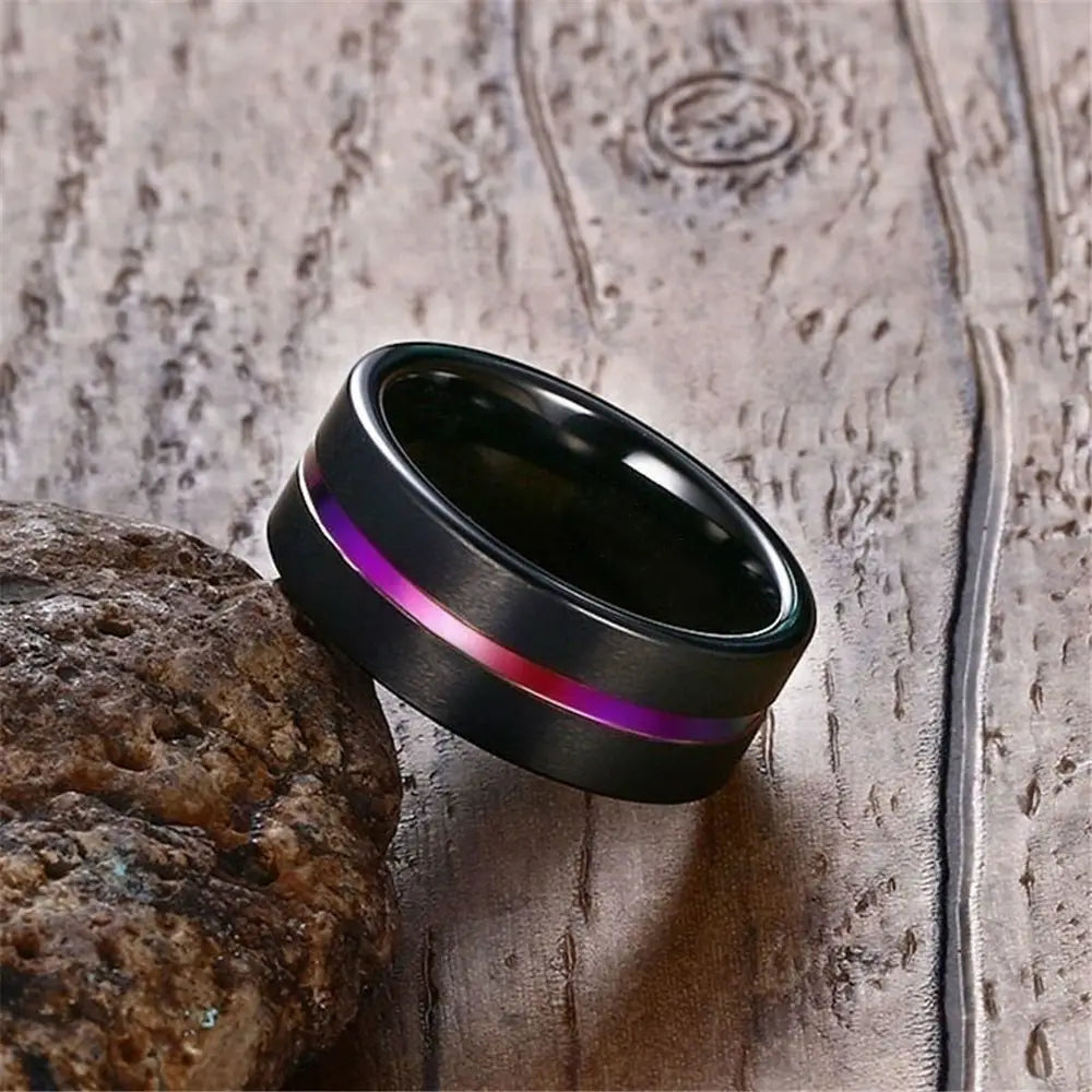 Black tungsten carbide wedding band with a polished finish and an embedded gradient stripe of purple to pink from the black tungsten and purple gemstone wedding band set.