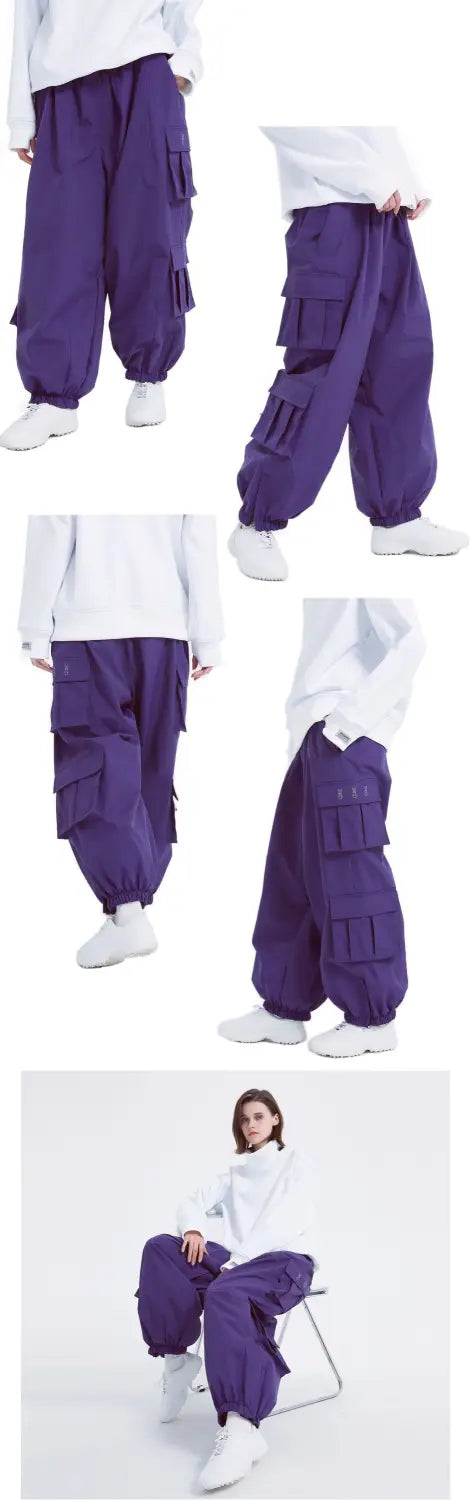 purple winter outdoor loose ski pants with multiple cargo pockets and a relaxed tapered fit designed for cold weather activities
