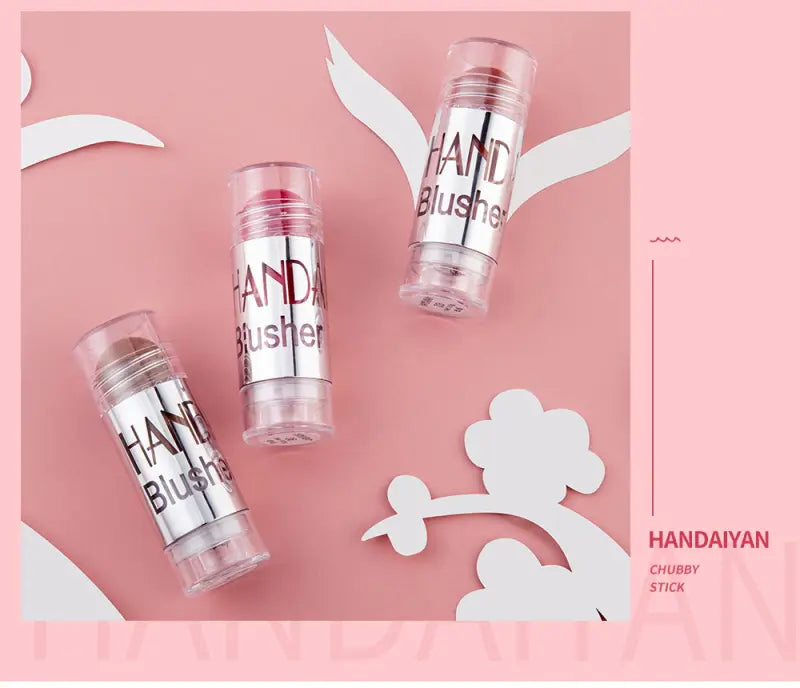 three transparent cylindrical cream blush sticks with silver metallic hand blusher labels in pink and peach shades for long lasting face highlighting in eight colors