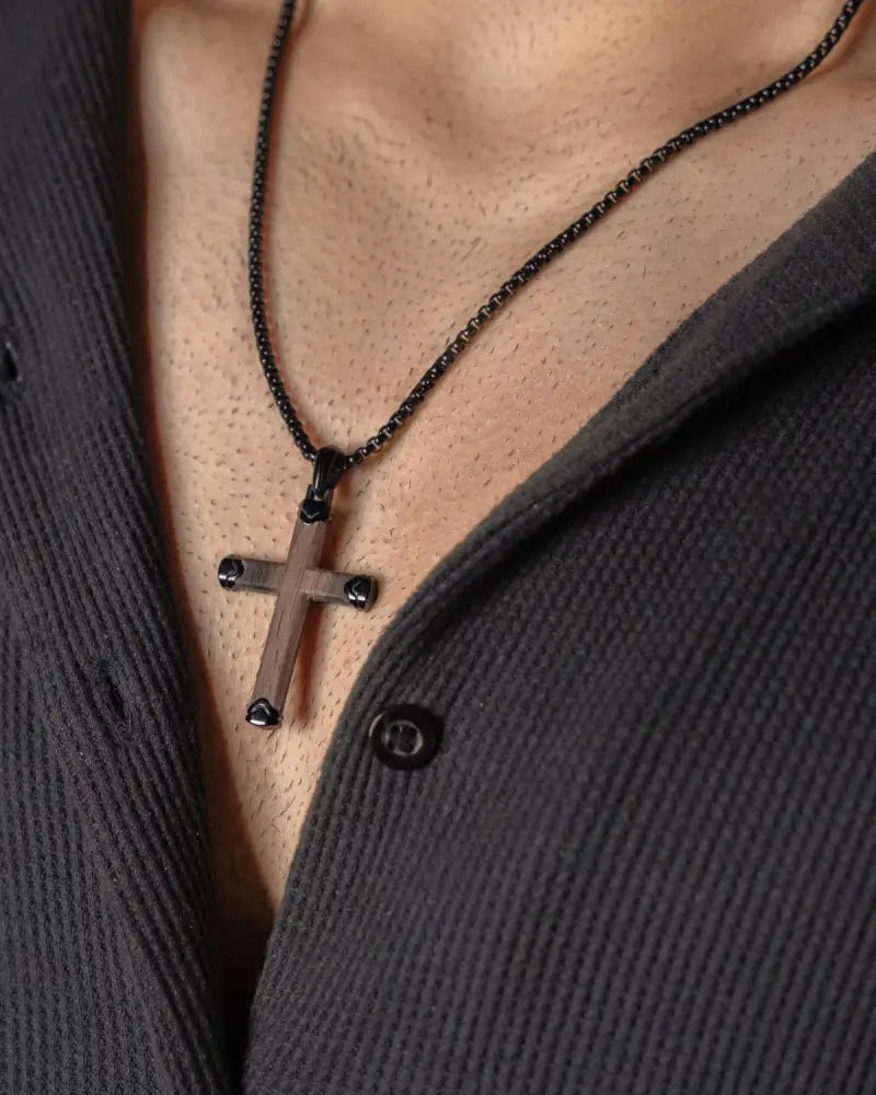 Matte ebony wood and black stainless steel cross necklace with matte finish and black spherical accents on dark chain