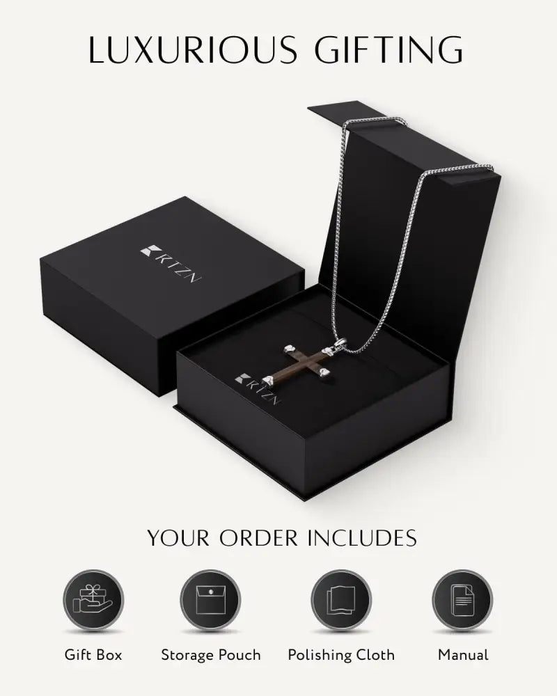 A sleek silver chain necklace with a dark brown ebony wood cross pendant in a black gift box