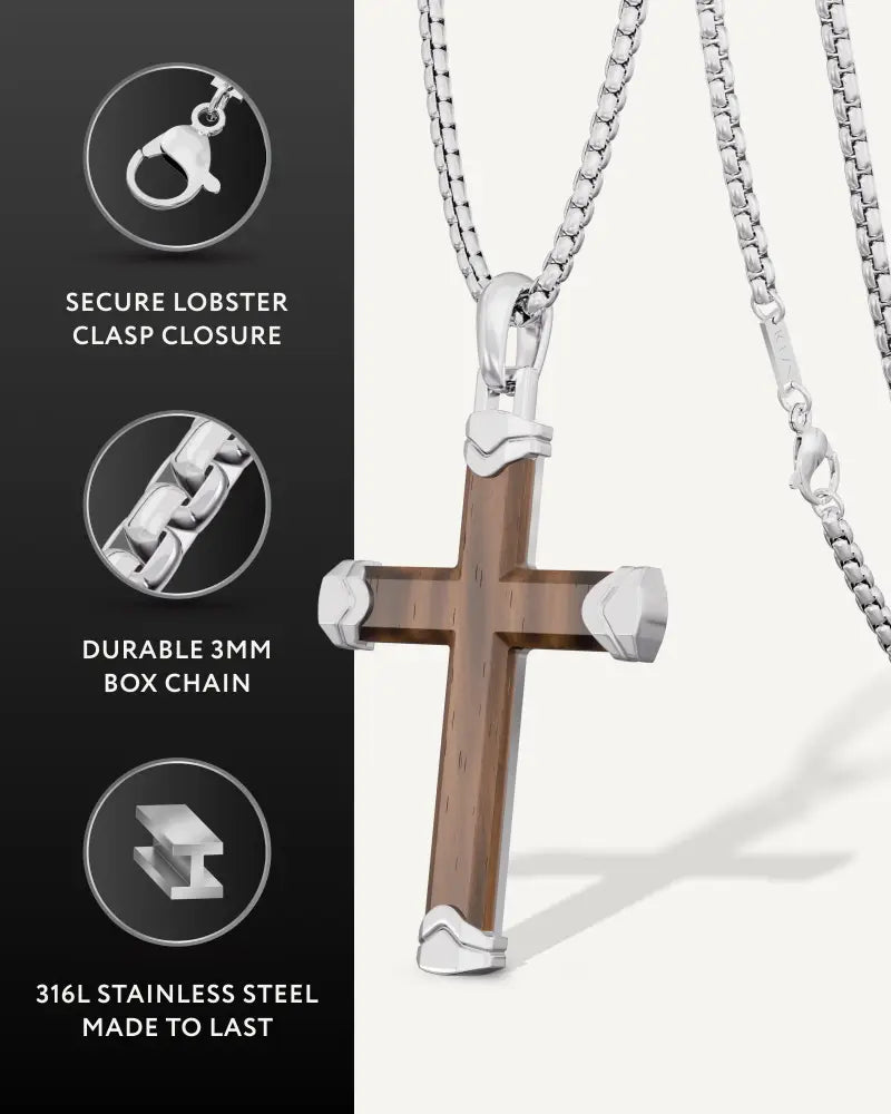 A sleek ebony wood silver cross pendant with warm brown center and polished silver accents on a 3mm box chain
