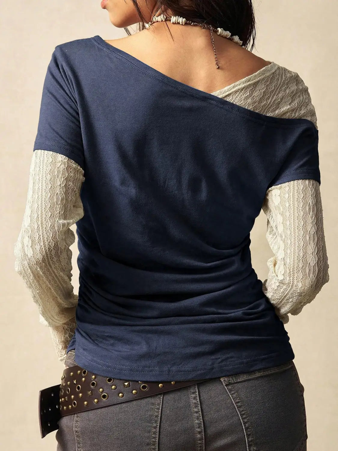 Navy blue lace layer off shoulder knitted top featuring sheer lace sleeves and a one-shoulder design.