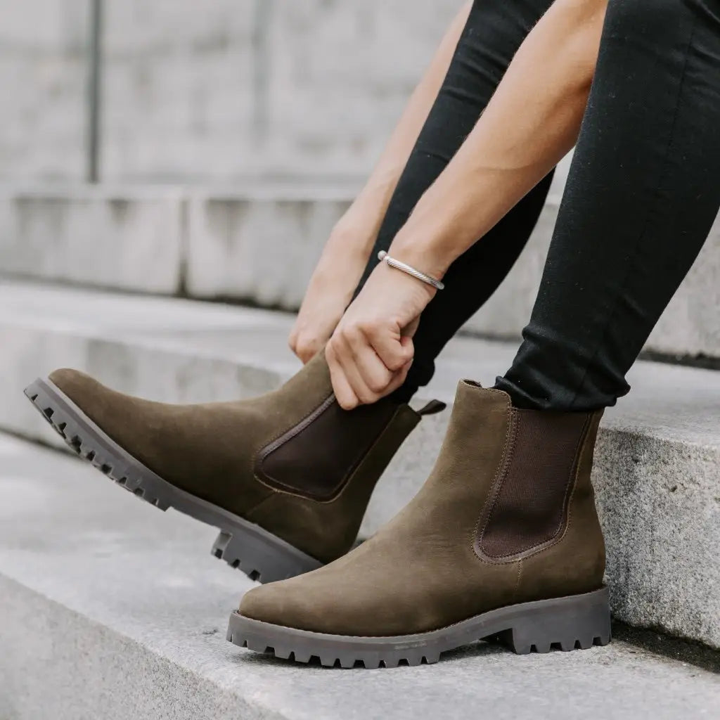 Brown suede Chelsea boots with chunky rubber platform sole and elastic side gussets displayed from the front angle.