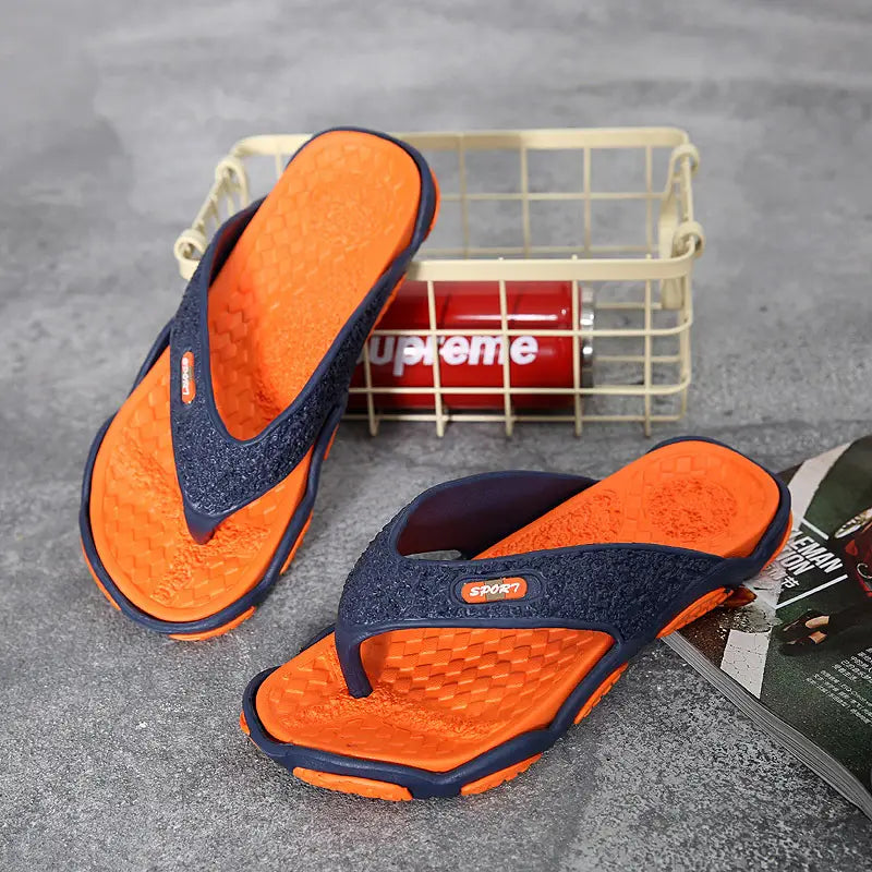 Men’s non-slip beach flip flops featuring orange and navy blue textured glittery uppers with an orange rubber sole and cushioned design.