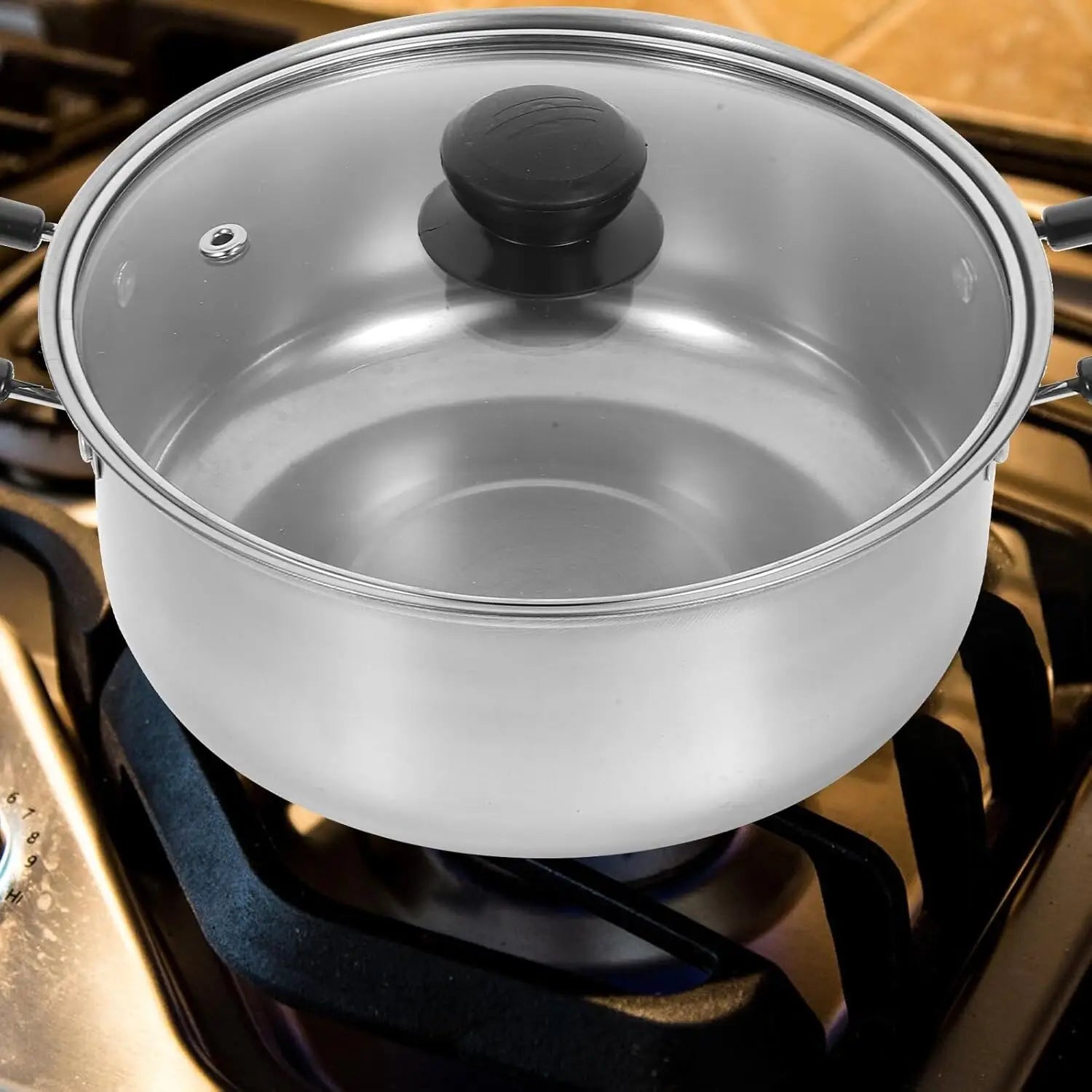 Stainless steel induction cookware set five pieces featuring a stainless steel pot with a clear glass lid and black handle.
