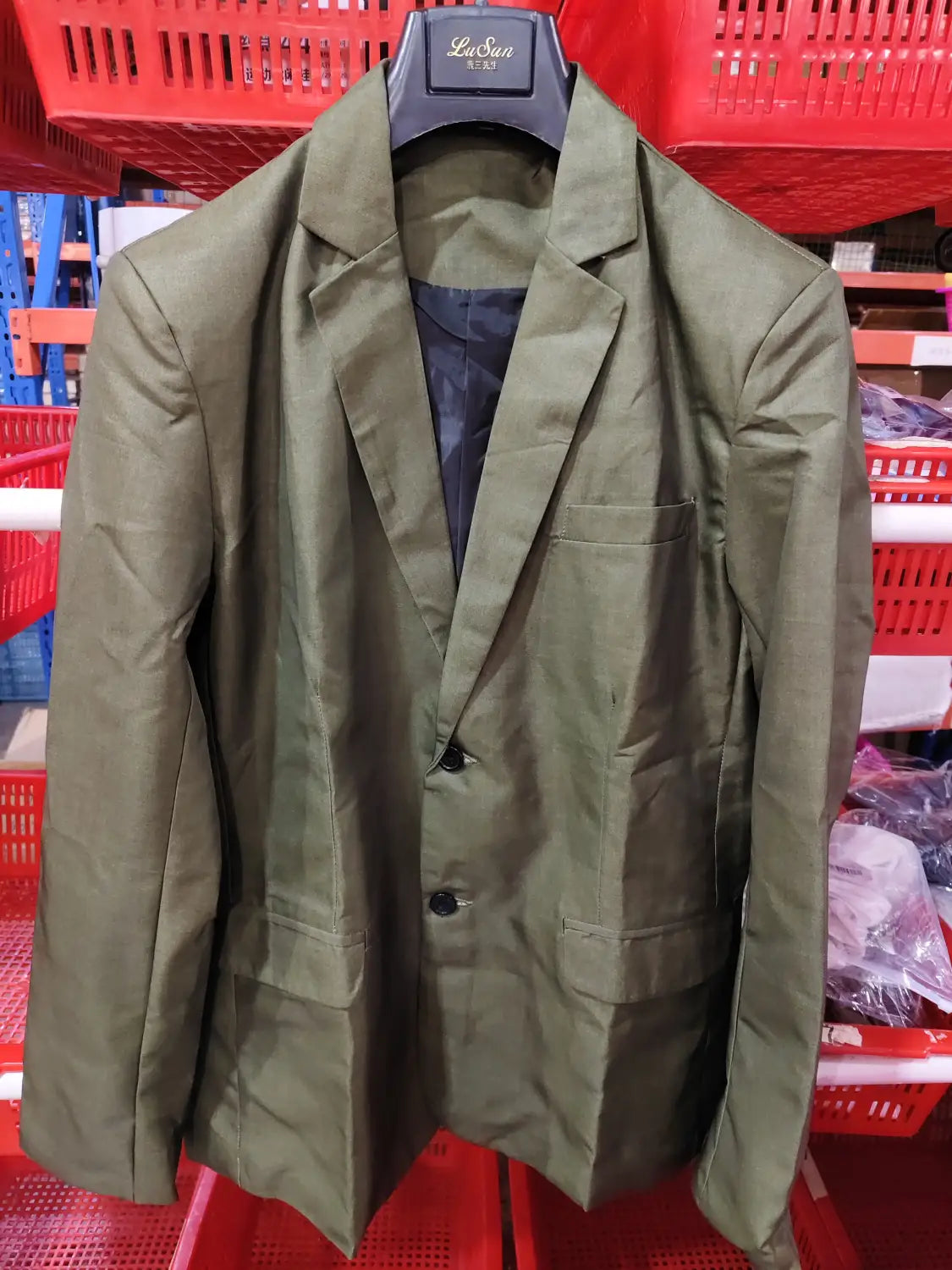 Men plaid blazer slim fit British style jacket in olive green with black buttons and dark blue inner lining hanging on a Lasua brand hanger