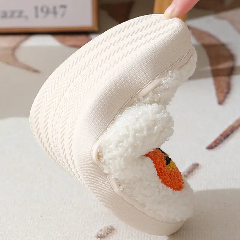 White plush jack-o-lantern embroidered Halloween slipper with a fluffy textured slip-on upper and orange detail on the toe.