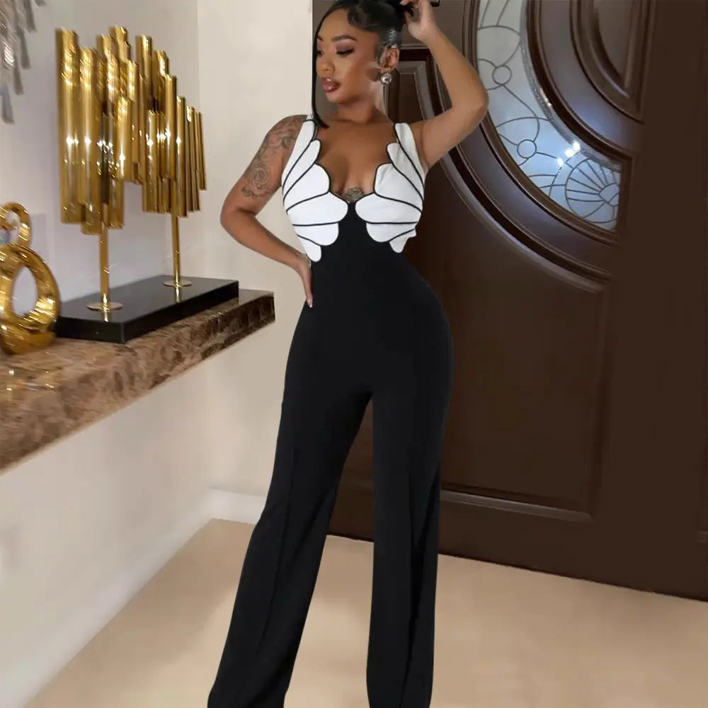 Black and white butterfly wing slim fit jumpsuit with a fitted bodice and wide-leg pants in a lightweight fabric.