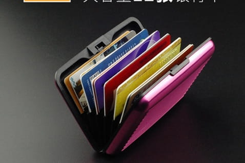 a sleek vibrant pink metallic rfid blocking aluminum alloy ribbed card holder case with black interior and multiple card slots