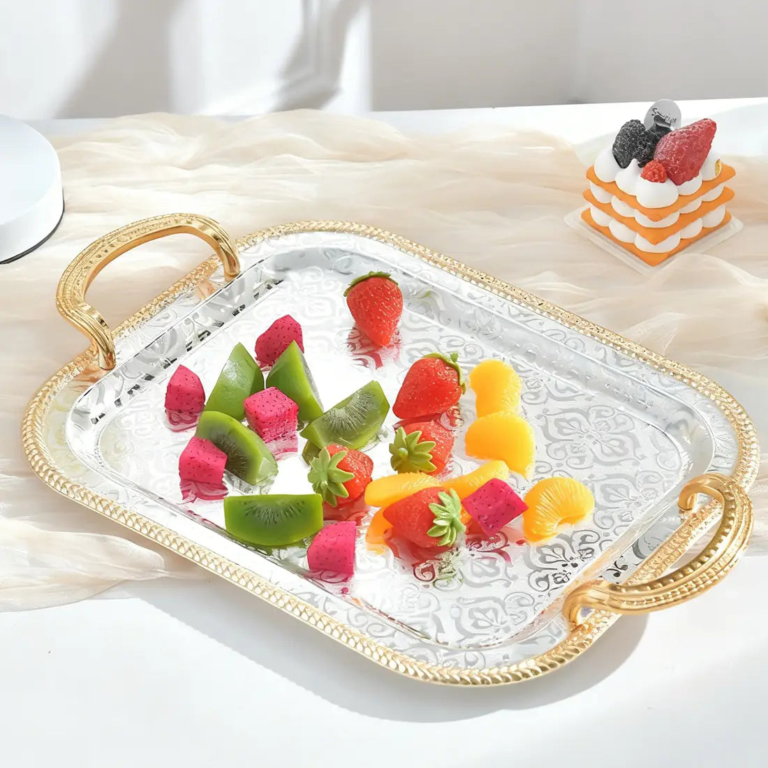 Luxury rectangle serving tray with gold-toned ornate handles and a silver-plated surface featuring intricate embossed patterns.