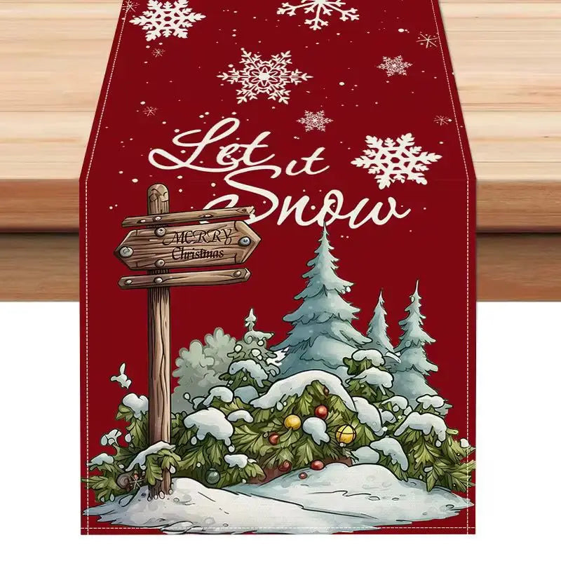 Red Christmas table runner 183x33 featuring white snowflake patterns and a wooden sign that reads let it snow with merry Christmas below against a snowy forest scene.