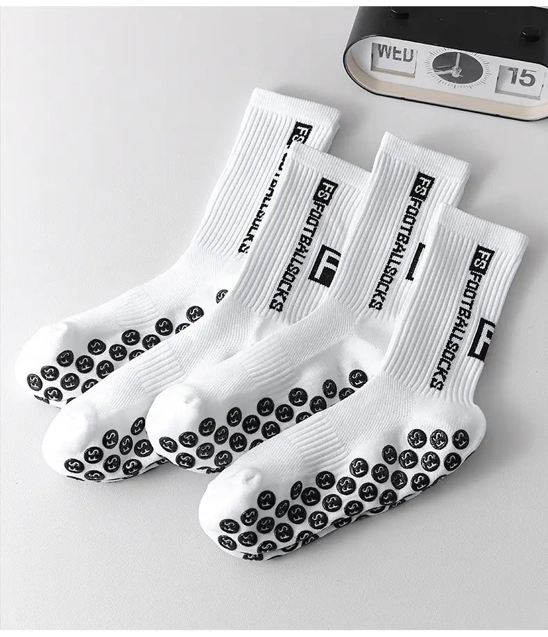 white athletic anti-slip football grip socks for men with black grip dots on the soles and fs football socks branding along the sides