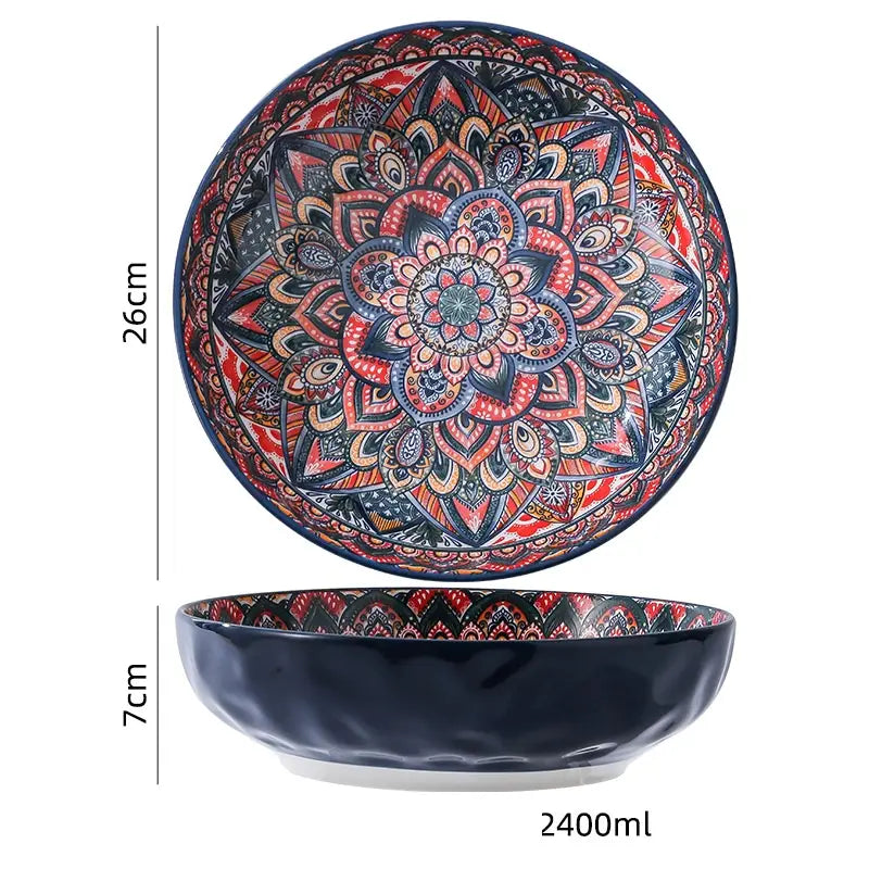 A vibrant hand-painted ceramic mandala serving bowl with intricate red orange and blue designs and a glossy black exterior with a 400ml capacity.