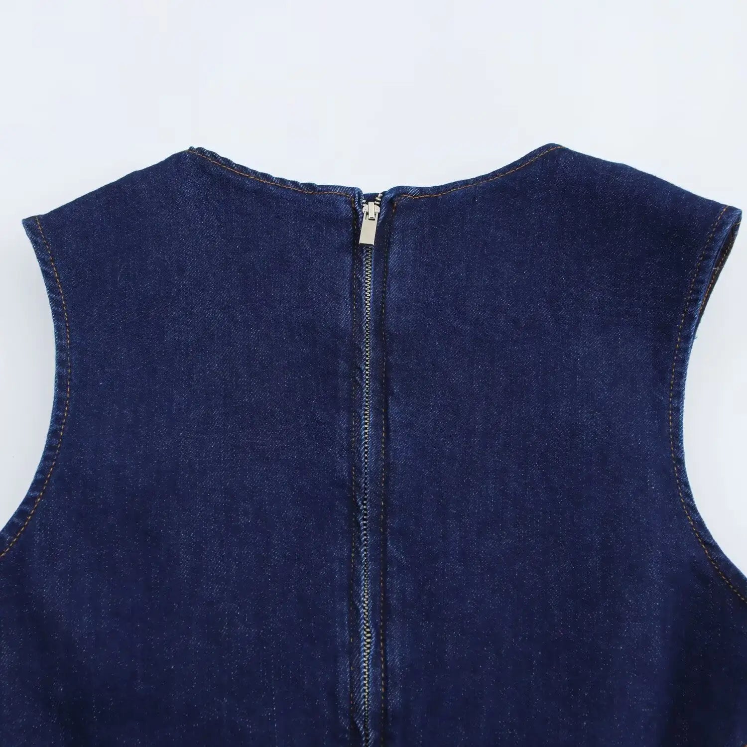 Navy crew neck sleeveless denim a-line dress featuring a dark blue denim sleeveless top with a central zipper closure.