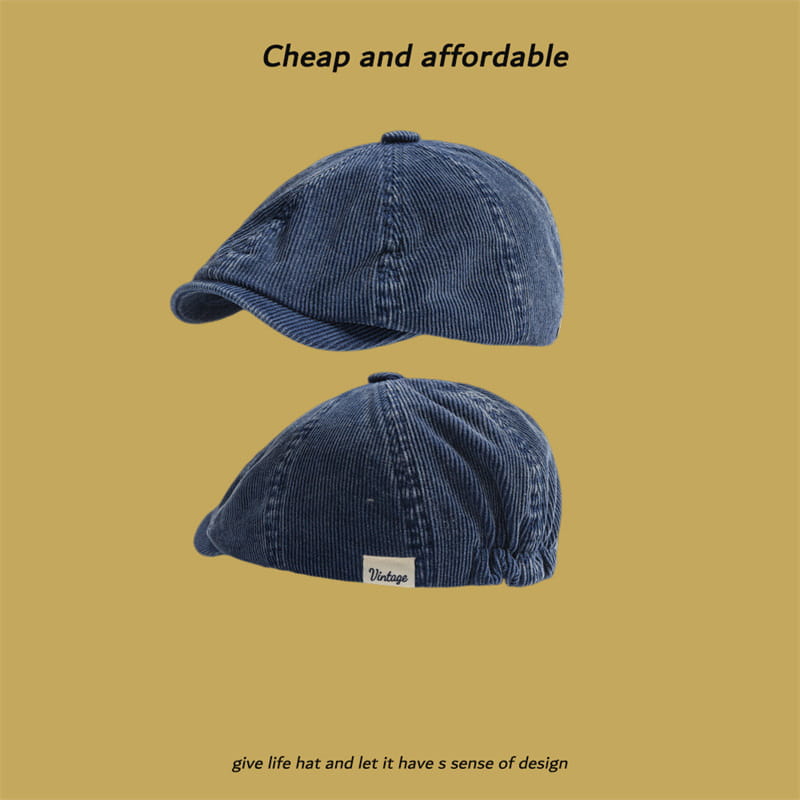Blue corduroy eight panel retro newsboy cap featuring a small white vintage label on the side.