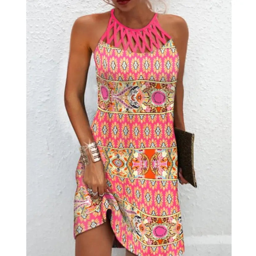 A vibrant pink geometric print halterneck asymmetrical midi dress featuring bold paisley patterns with orange white and gold accents.