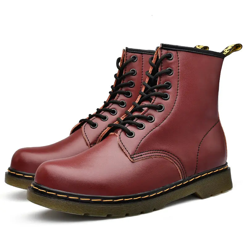Burgundy leather martin boots with yellow stitching shown from the back side.