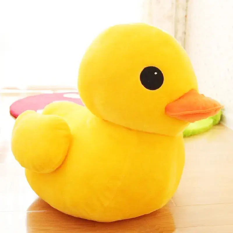 Ein flauschiges gelbes Gummienten-Weichstofftier mit schwarzem Auge und orangefarbenem Schnabel, mit einer Größe von 20 bis 50 Zentimetern.