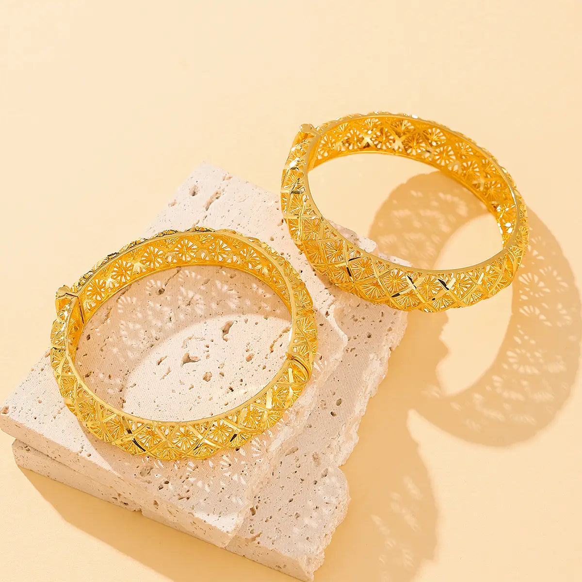 vintage 18k gold plated filigree four leaf clover bangle featuring golden bangles with intricate floral patterns and a polished metallic finish