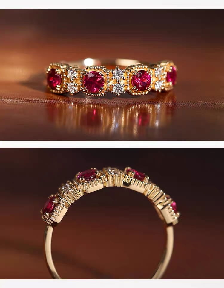 18k gold plated band ring featuring five prominent round red pigeon blood rubies set in ornate bezels, each flanked by smaller clear diamonds.