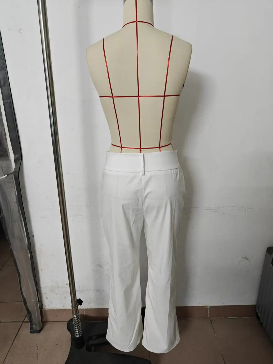 white tailored trousers with a straight-leg cut and belt loops displayed on a mannequin designed as wide leg work pants high waist casual trousers