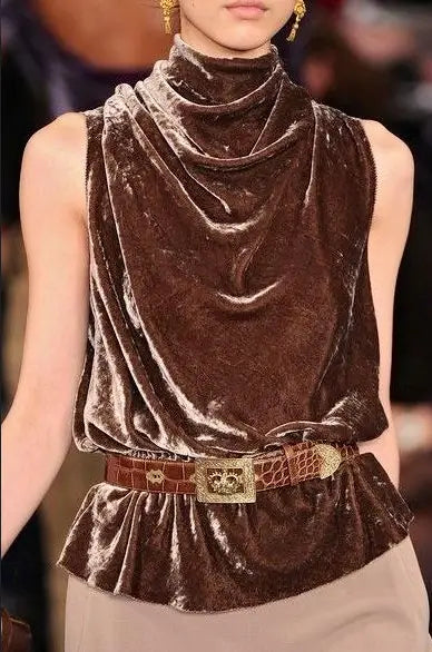 A rich brown velvet slouchy sleeveless top with a high draped neckline and peplum hem.