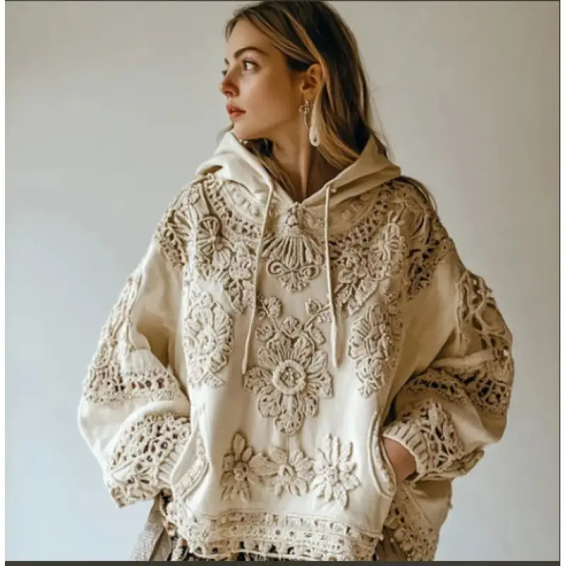 Cream-colored beaded floral lace 3d printed hooded jacket with intricate lace embroidery in a floral pattern on the front and sleeves.