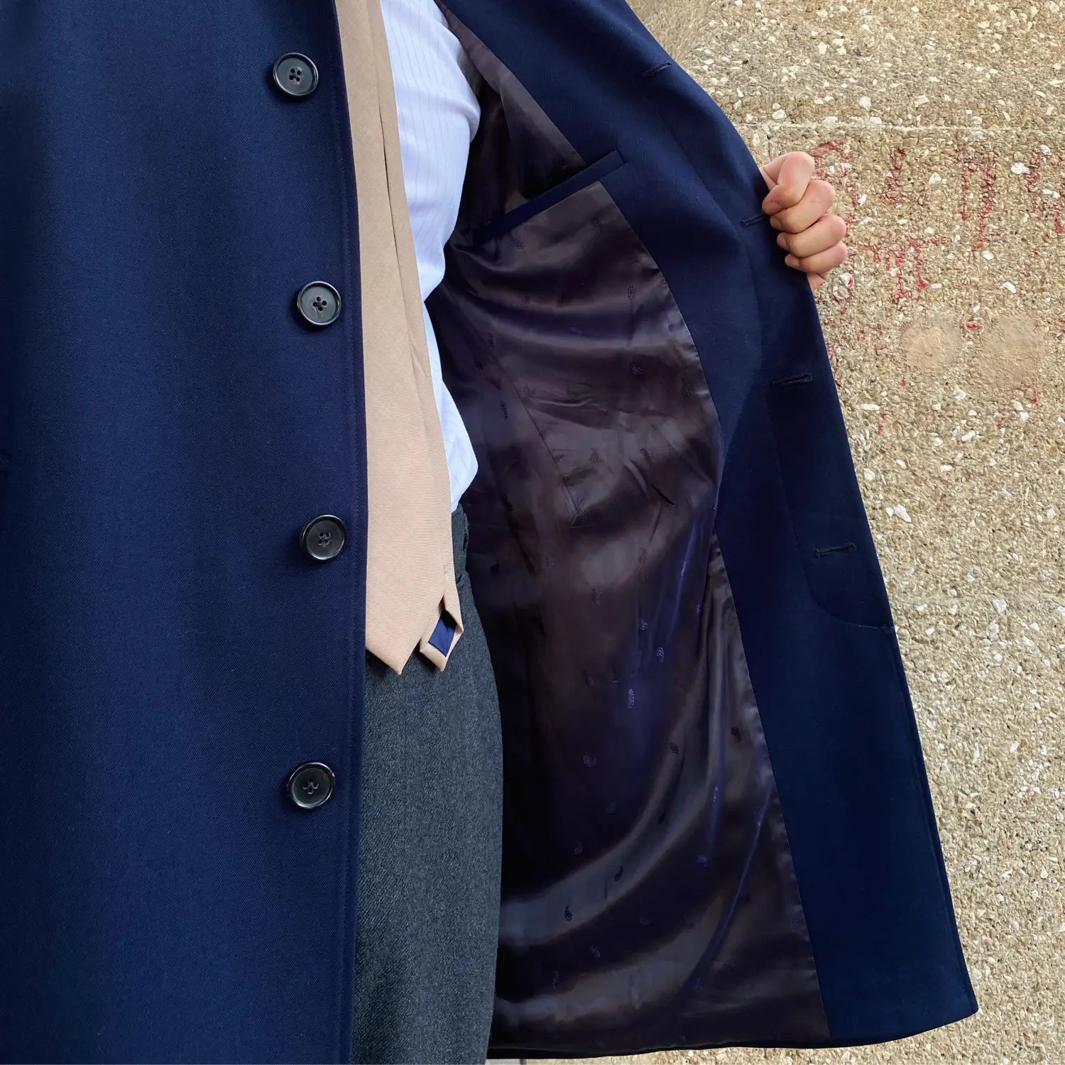 Navy blue wool winter trench coat single-breasted with black buttons and satin-lined interior.