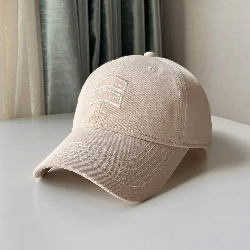 Beige men’s large fit cotton baseball cap featuring a subtle white embroidered logo on the front.