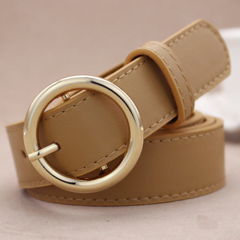Beige leather belt for women featuring a gold-toned round buckle, designed as a versatile fashion accessory.