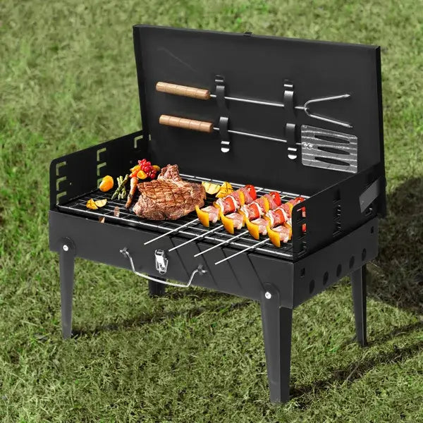 Black portable charcoal grill 44cm folding square bbq steel with wooden-handled tools and built-in rack for skewers.