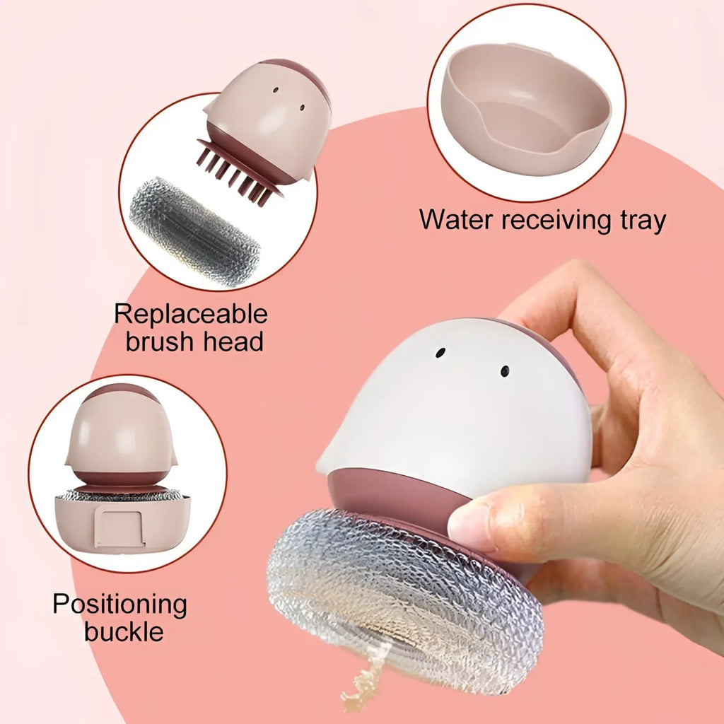 A pastel pink and white silicone egg dish brush scrubber with mesh bristle head and automatic liquid soap dispenser