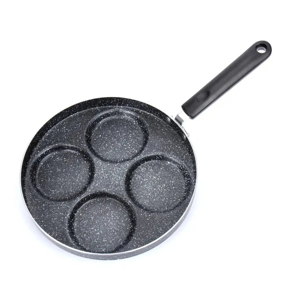 Black speckled nonstick 4-cup egg and pancake pan with four circular molds and black handle for breakfast cooking