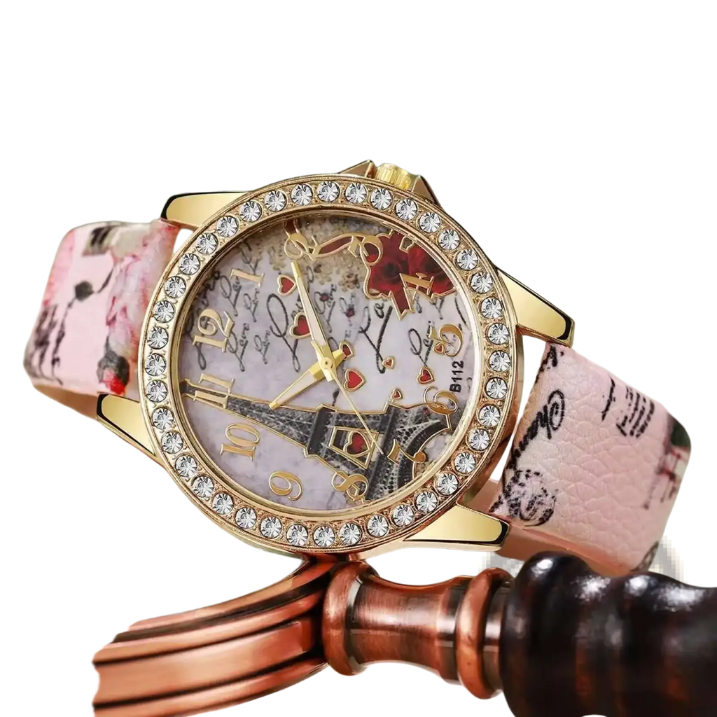 Eiffel Tower floral quartz women watch with pink floral strap, gold-tone crystal bezel, and illustrated dial design