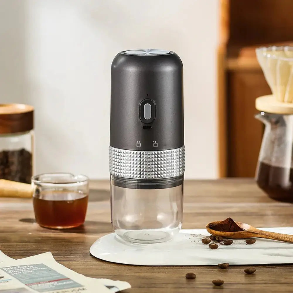 Compact automatic electric coffee grinder in black and silver with a textured metallic band for efficient grinding