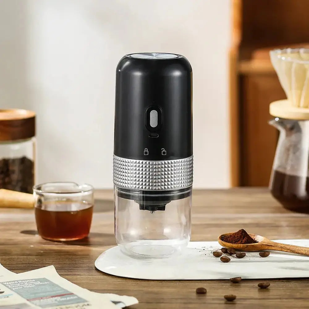 Black and silver compact automatic electric coffee grinder with textured metallic band for efficient grinding