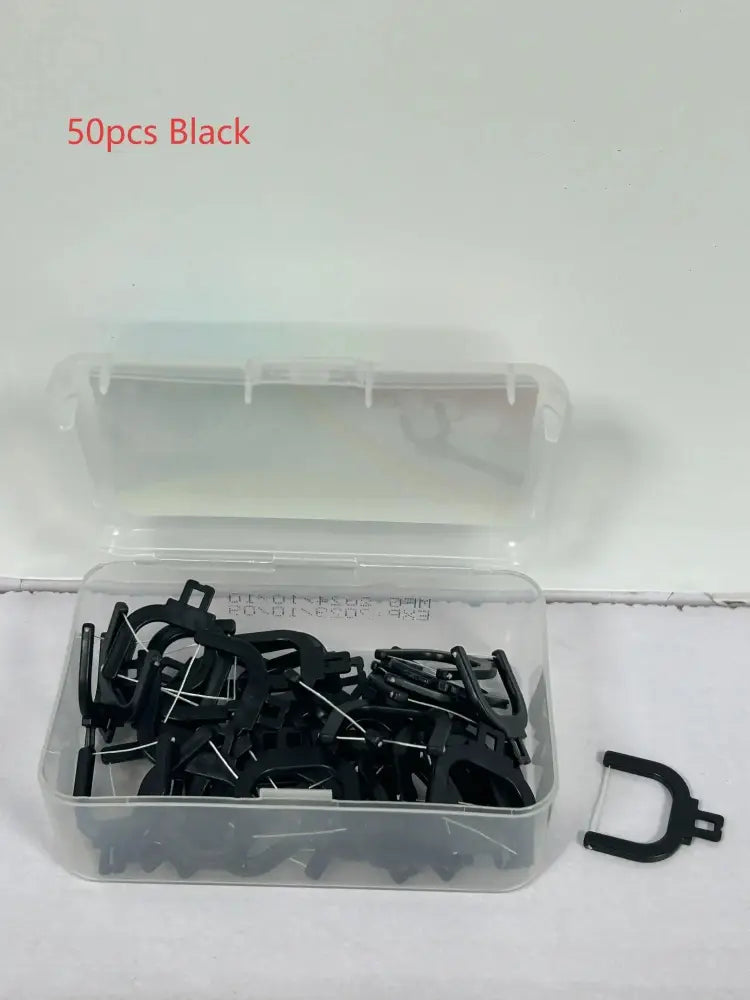 Black plastic dental floss picks in a clear container for professional electric water flosser deep dental care use