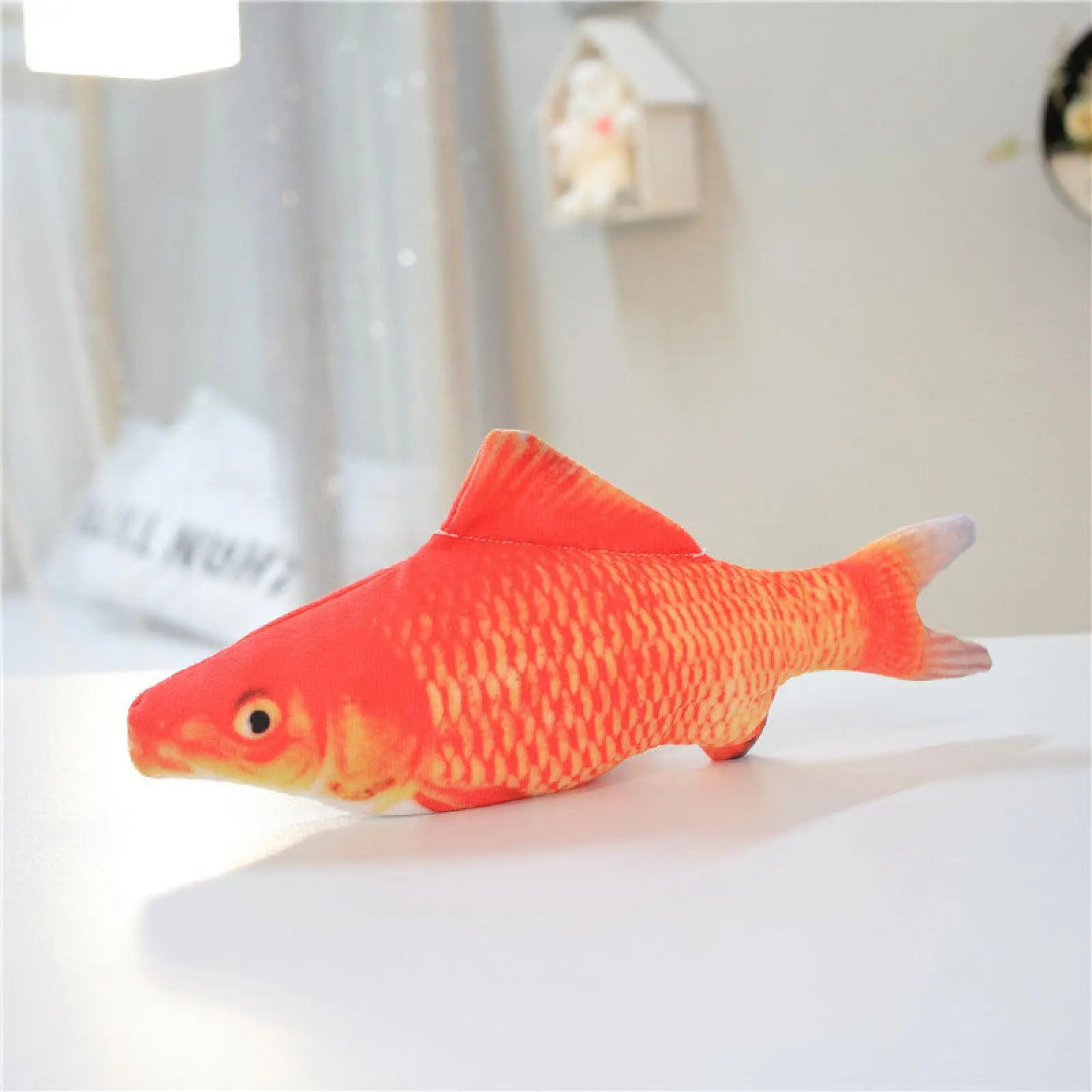 A plush orange goldfish electric jumping fish cat toy with textured scale pattern and embroidered eyes no catnip version
