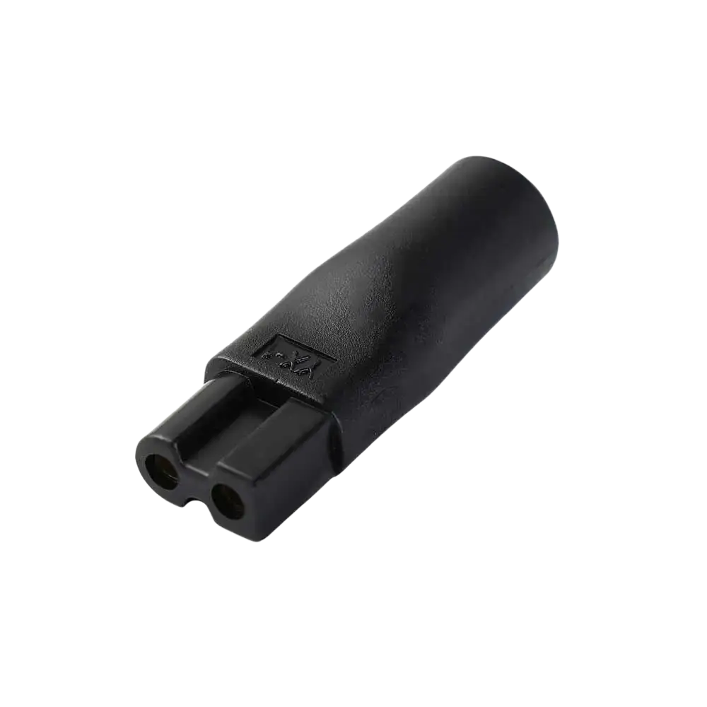 Black plastic electrical plug adapter with two circular openings and textured surface for electric shaver usb charging set
