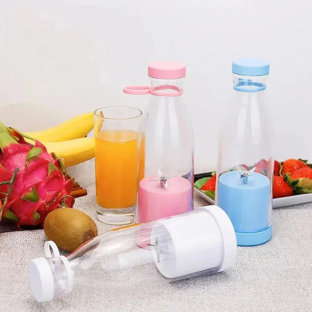 Clear plastic portable usb rechargeable personal blender and juicer cup with pink and blue lids and integrated blades