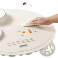 Cream-colored circular induction cooktop with smooth glossy surface and raised edge on electric warming tray rollable mat with timer