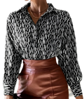 Elegant black and white patterned satin button up blouse with long sleeves and a collar shown from the front