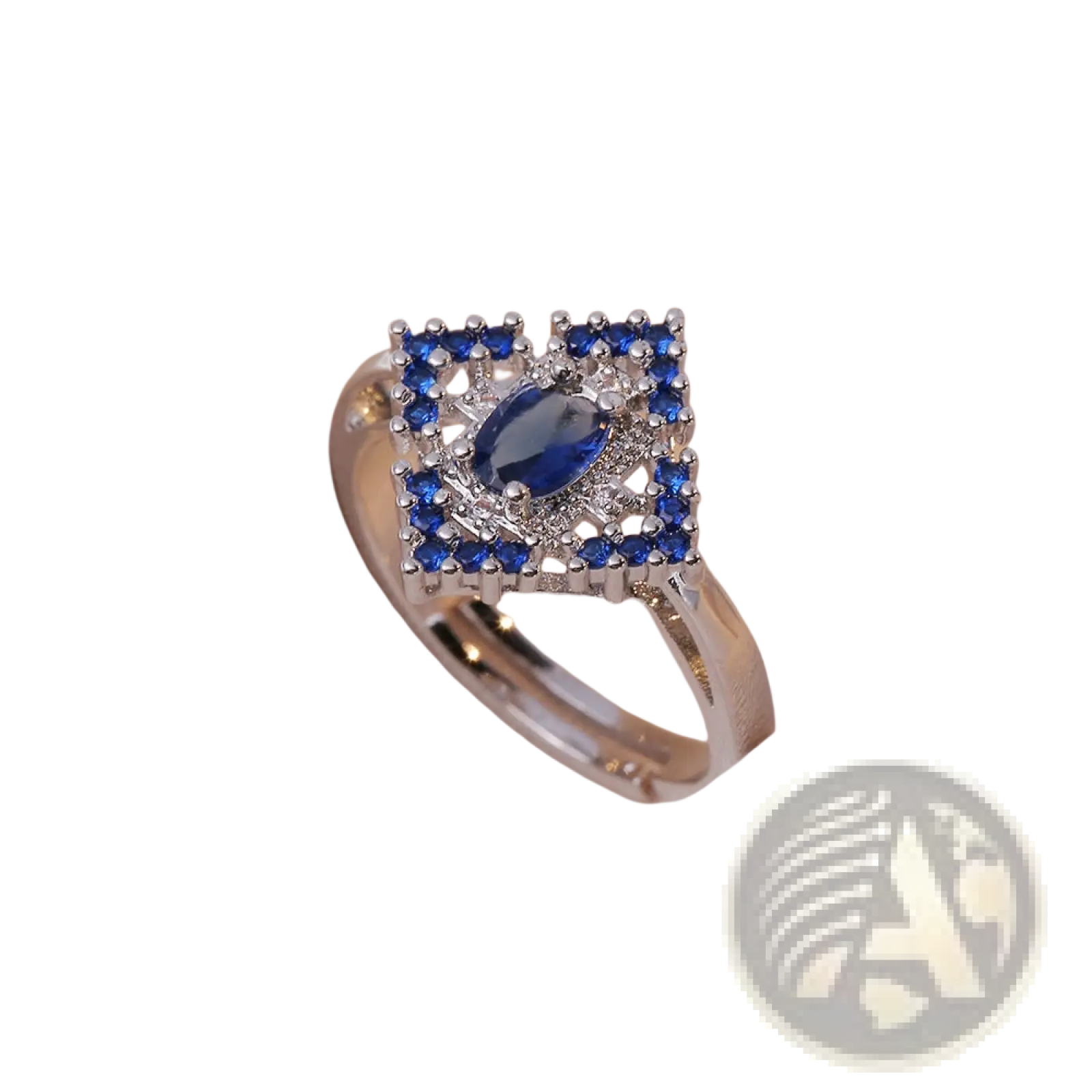 A silver ring with an oval blue zircon gemstone and smaller blue and clear stones in an intricate square design