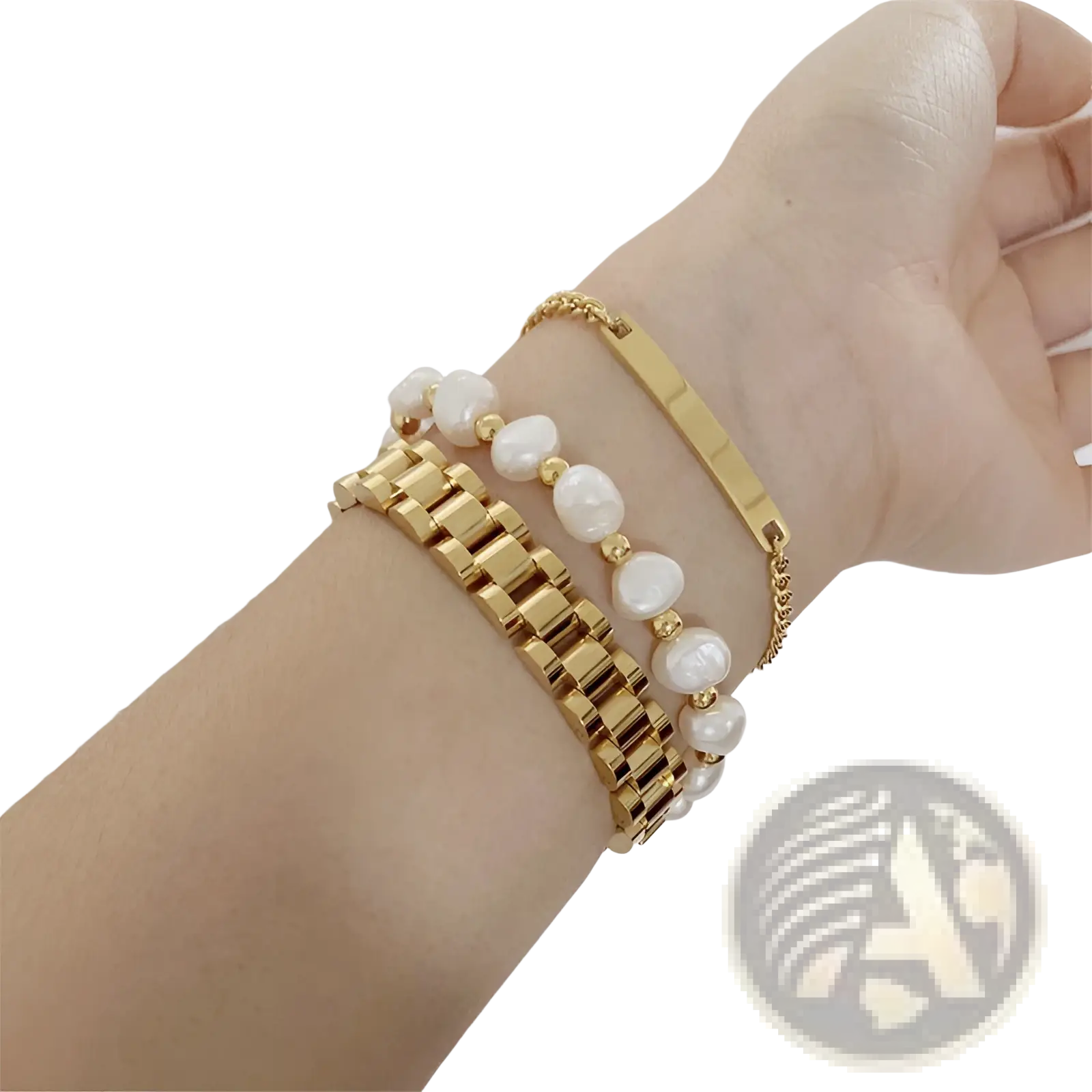 Elegant gold titanium link bracelet with pearl accents stacked with gold-toned pearl and metal bracelets on wrist